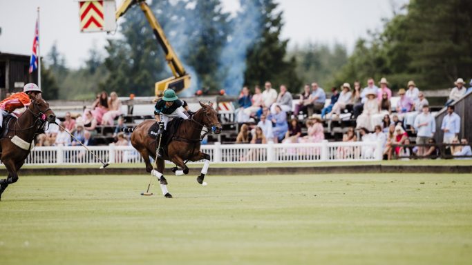 Polo event coverage Polo player riding past spectators beside the field
