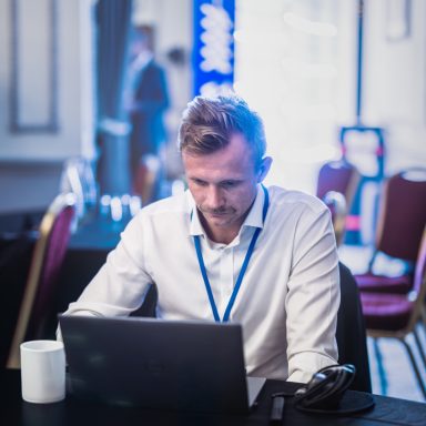 Between sessions Business event attendee working on a laptop between sessions