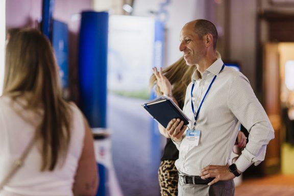 Event attendee Business event attendee holding a tablet and wearing a lanyard